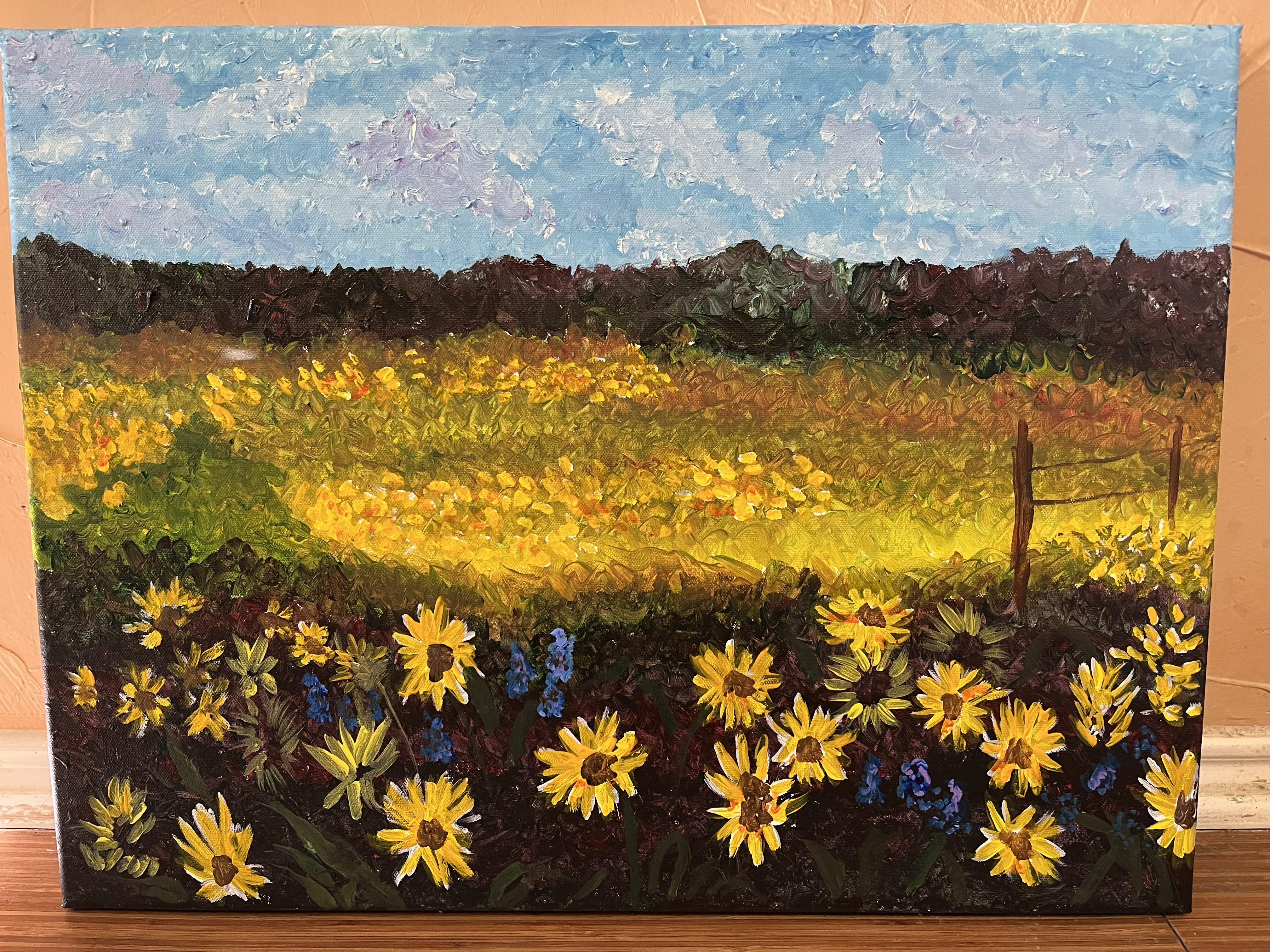 A field of sunflowers with bluebonnets